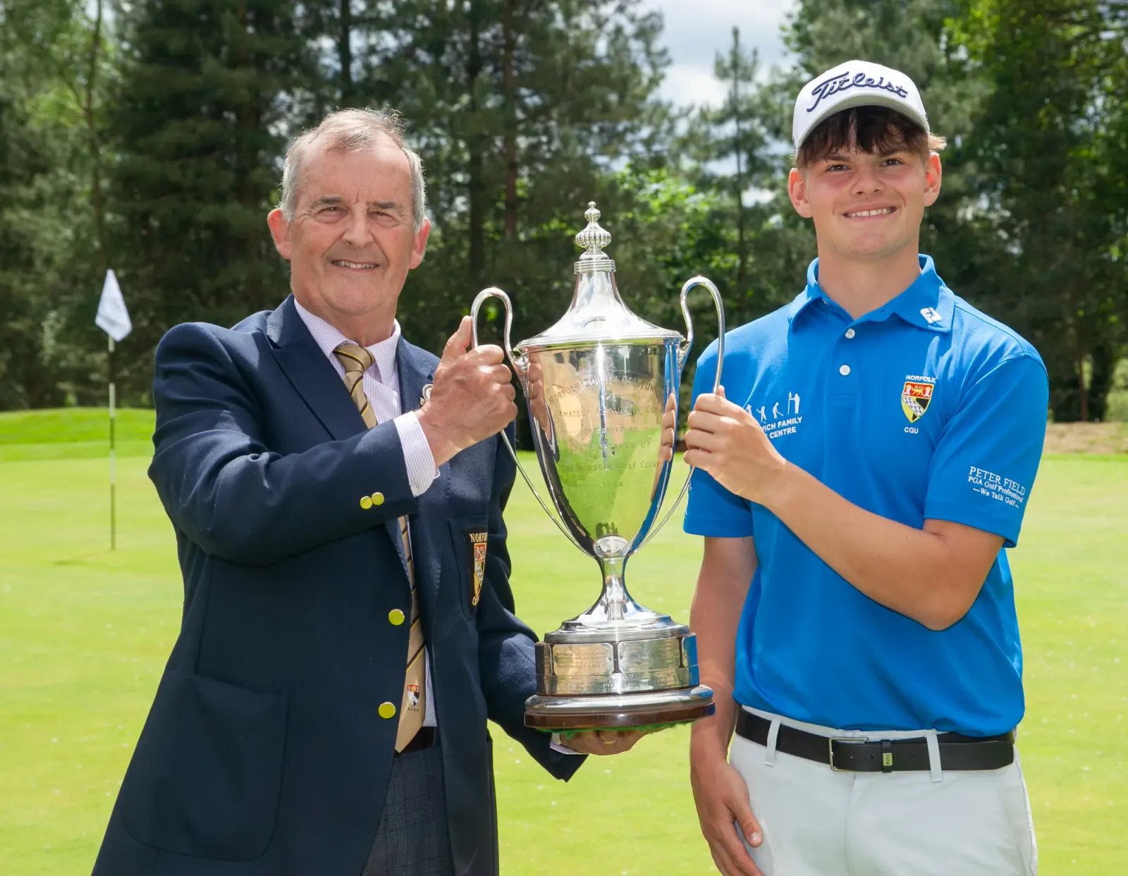 Norfolk County Golf Union president Stuart Goodman hands over the silverware to Norfolk Amateur champion Sully Goddard
